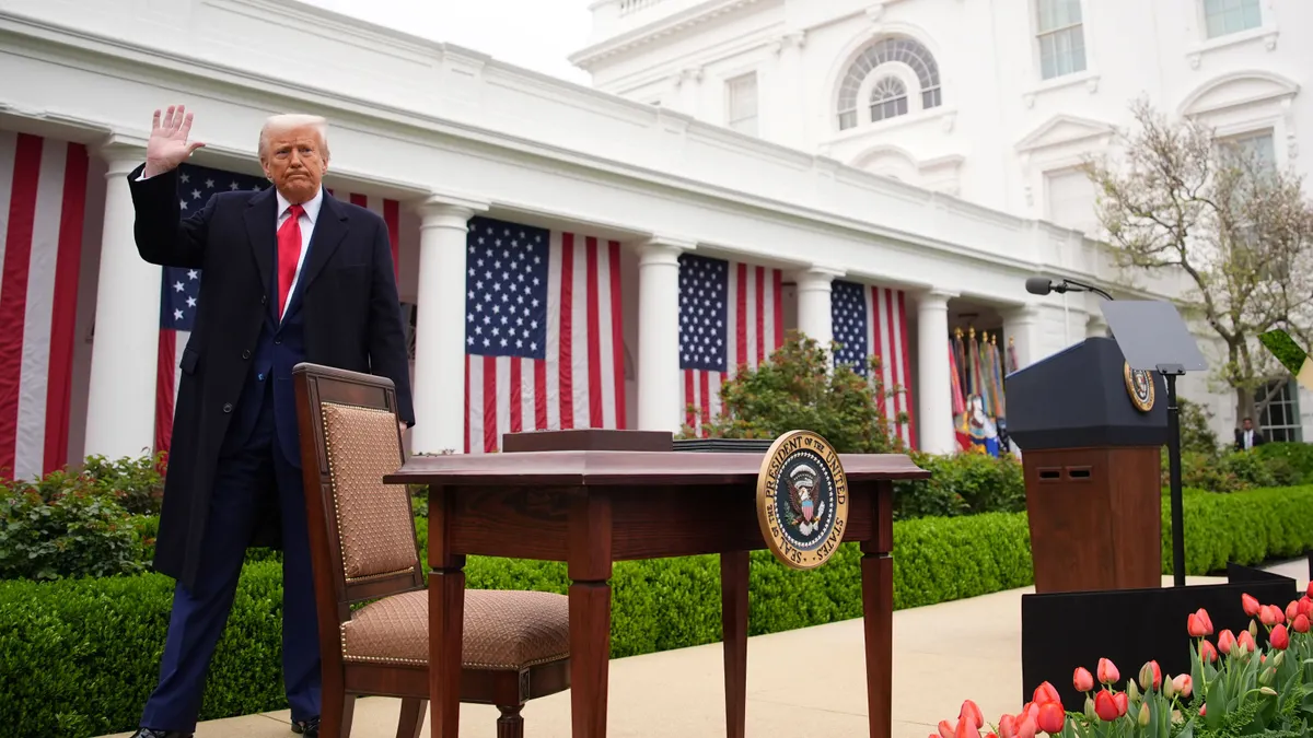President Donald Trump waves to a crowd at the White House on April 2, 2025.