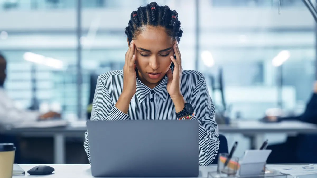 Woman infront of laptop stressing out