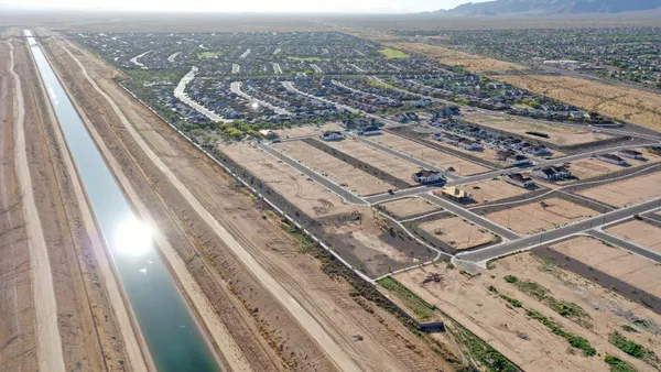 Aerial view of several homes in an arid landscape.