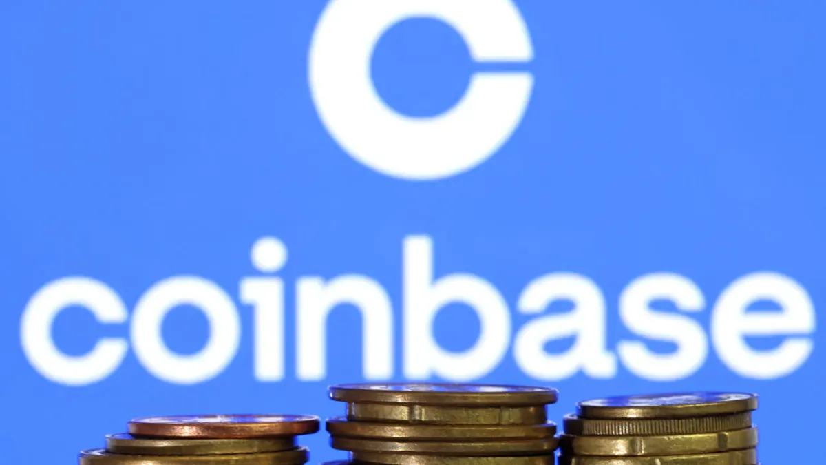 coinbase logo with coins stacked in front of it
