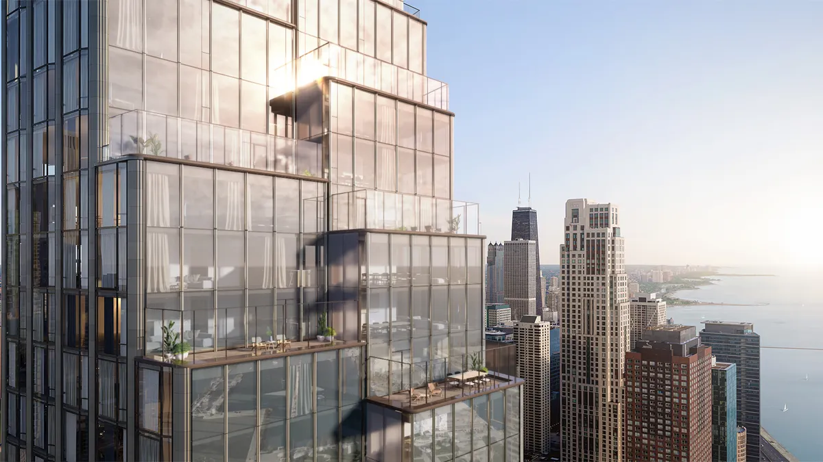 The top of a tall glass building, with balconies.