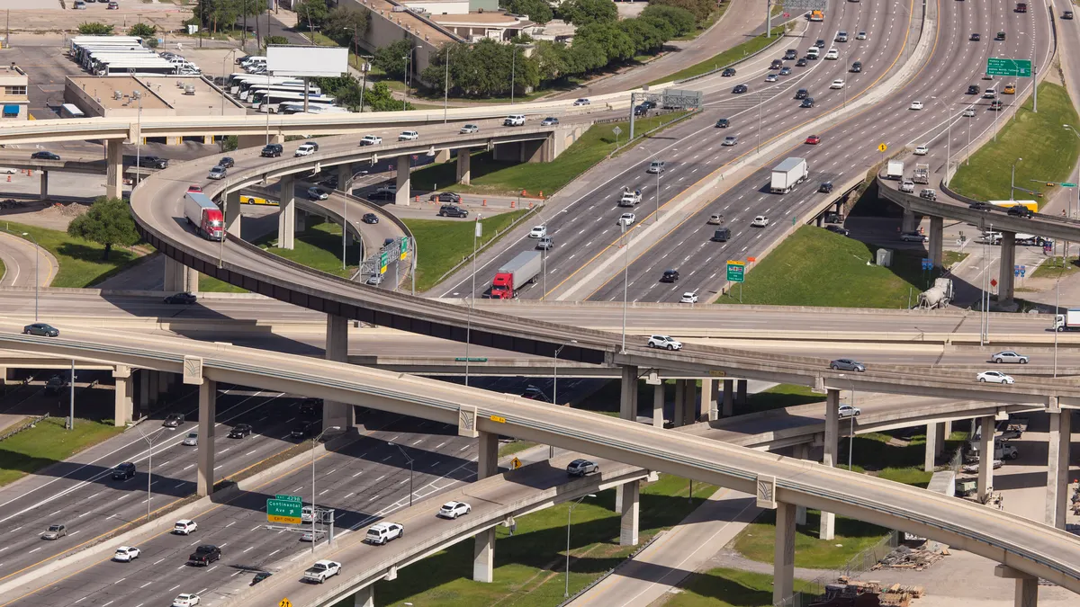 An overhead shot of a cluster of highways near a city.