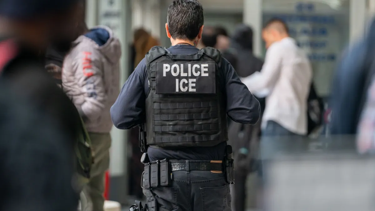 ICE agent monitors asylum seekers at immigration center