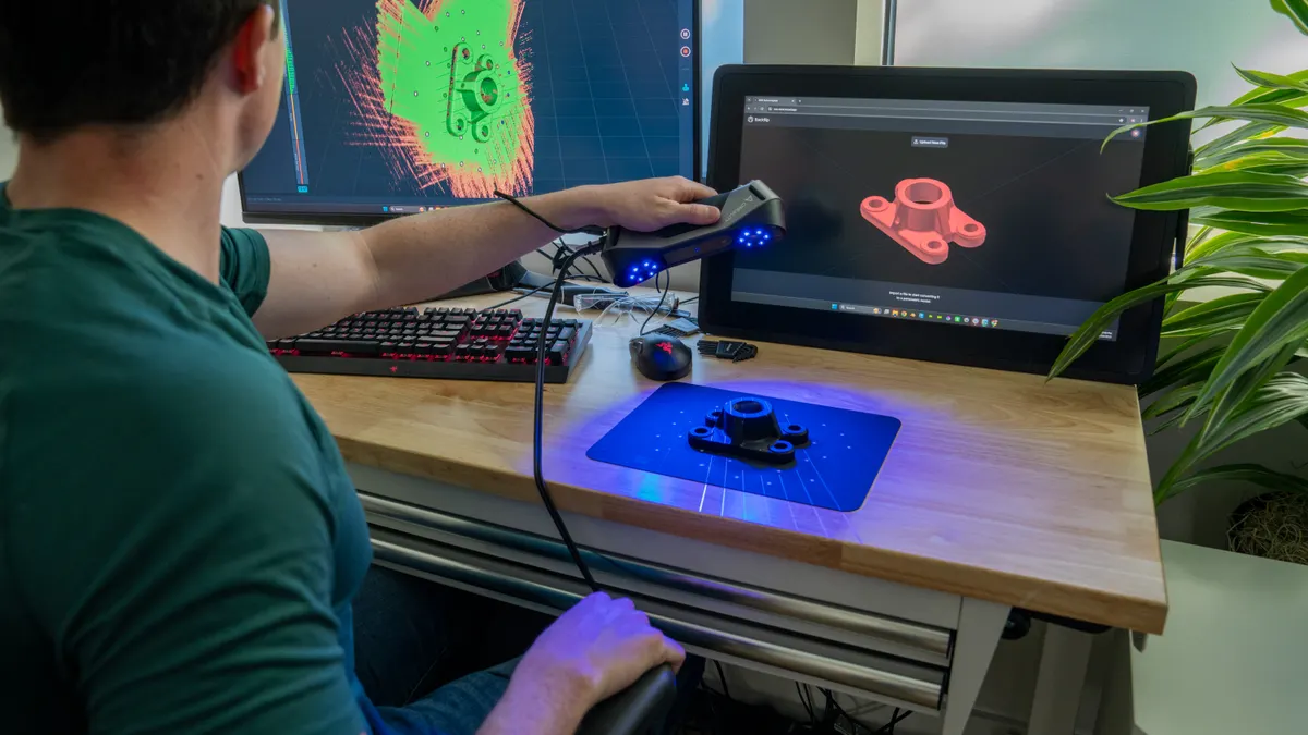 A user 3D scans a component to build a point cloud that precisely maps the surface of the part.